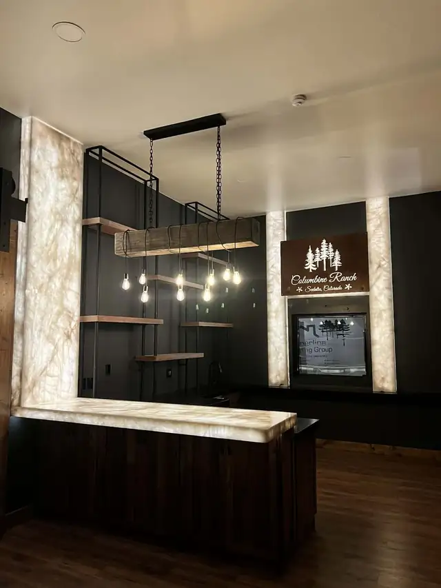 Backlit translucent stone bar top and wall columns at Columbine Ranch, Sedalia, Colorado